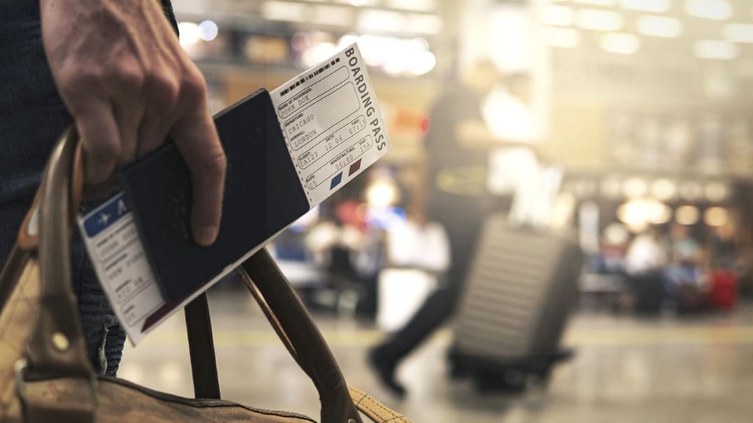 Physical Presence Test requirements illustrated by traveler with boarding pass and luggage
